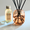 NEOM real luxury reed diffuser bottle and diffuser on a light background