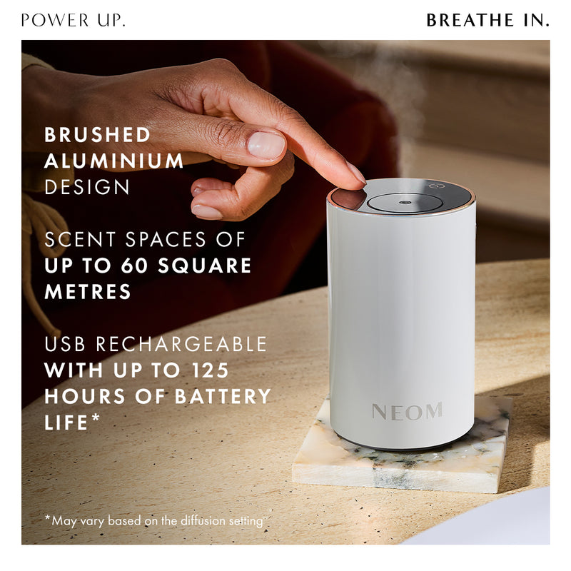 Neom diffuser on a table with promotional text about its features