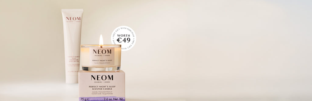 NEOM magnesium body butter with a candle on a beige background