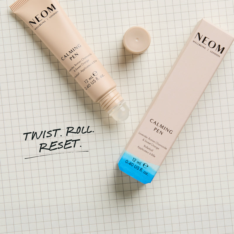 NEOM Calming Pen on a checkered background with text saying 'Twist. Roll. Reset.'
