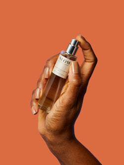 NEOM Perfect Night’s Sleep mist held in hand for bedtime relaxation and wellbeing