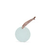 Round light blue soap with a pink ribbon on a white background