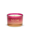 Neom candle with pink and gold design on a white background