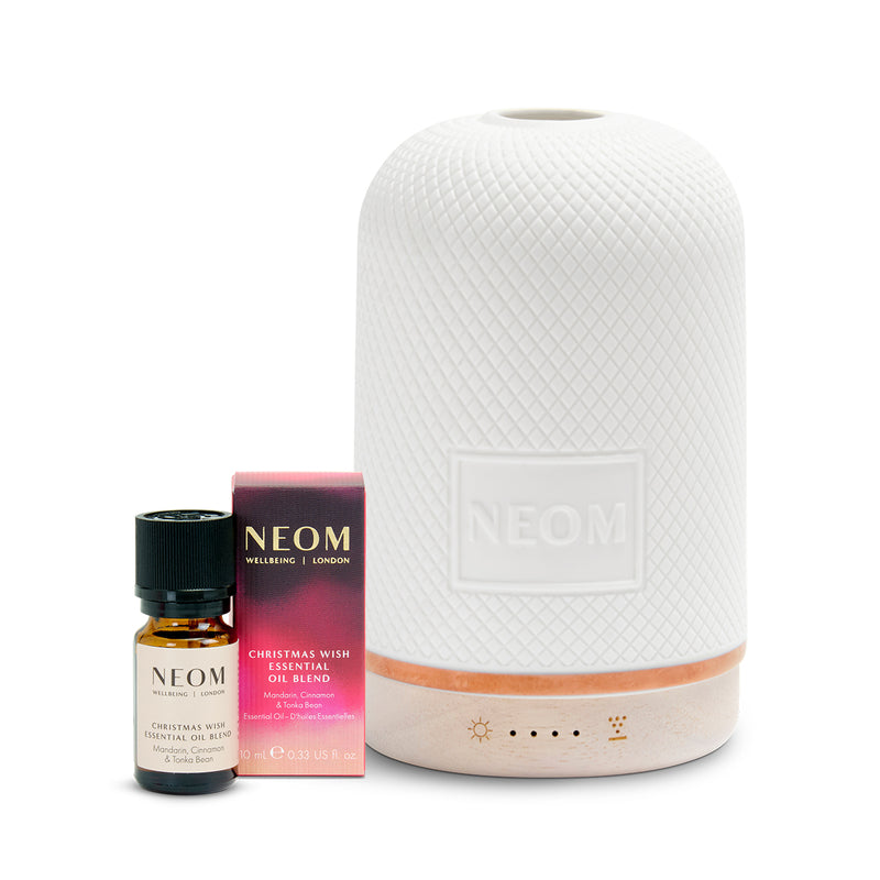 Neom diffuser and essential oil set on a white background