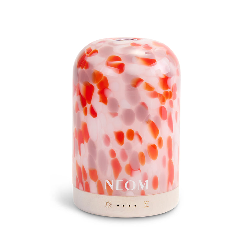 NEOM diffuser with a pink and orange abstract pattern on a white background