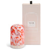 NEOM diffuser with floral design and matching packaging on a white background