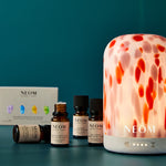 NEOM products  on a teal background