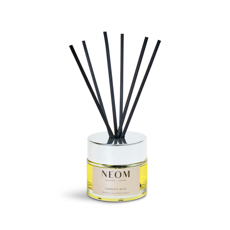 NEOM reed diffuser with black reeds on a white background