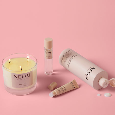NEOM wellbeing products with scented candle, sleep mist, calming pen and body cleanser