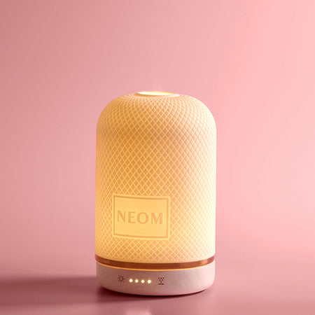 NEOM essential wellbeing pod oil diffuser with warm ambient light and mist for aromatherapy and home fragrance