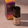 NEOM Cosy Night's essential oil blend bottle and packaging on a neutral background