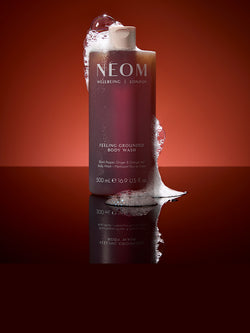 NEOM Feeling Grounded body wash with black pepper, ginger and orange oils with foaming texture