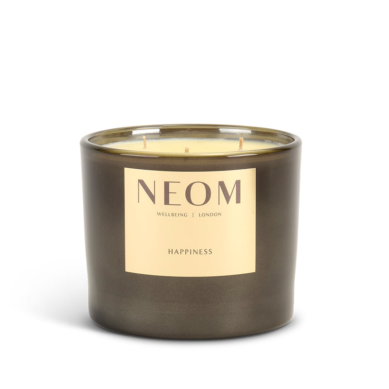 NEOM limited edition Happiness scented 3 wick candle on a white background