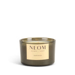 NEOM happiness scented candle with a gold label on a white background