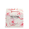 NEOM product packaging with floral design on a white background