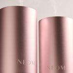 Two pink NEOM diffusers on a light gray background