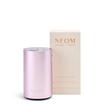 Pink NEOM diffuser with packaging on a white background
