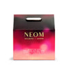 NEOM product packaging with a gradient pink and purple design on a white background