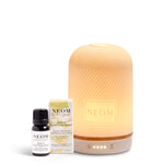 NEOM  diffuser, essential oil blend, and bottle on a white background