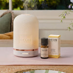 NEOM Wellbeing Pod essential oil diffuser with Happiness essential oil blend.