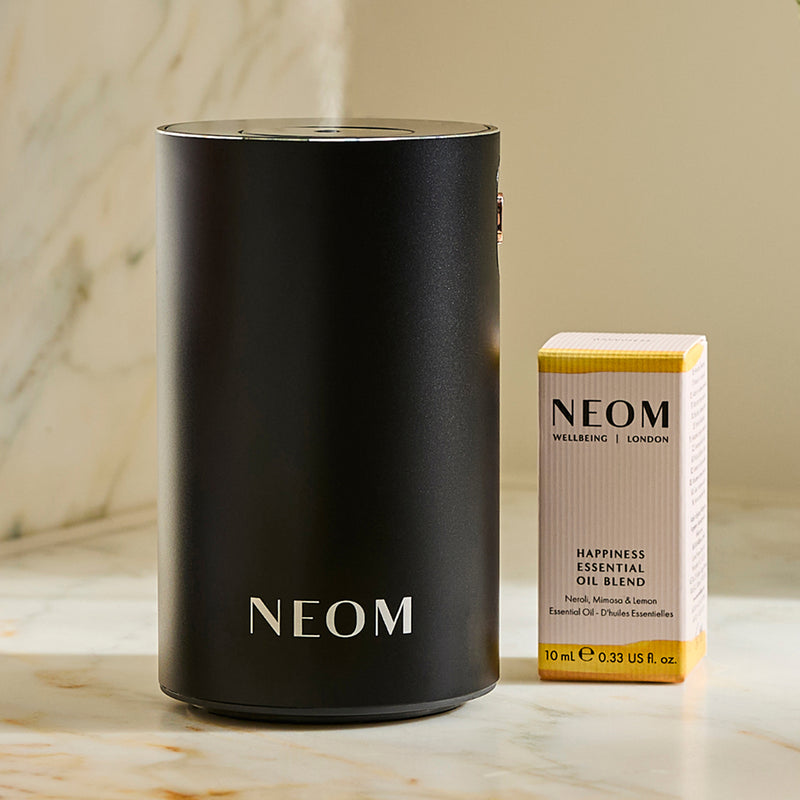 NEOM Wellbeing Pod essential oil diffuser with Happiness essential oil blend.