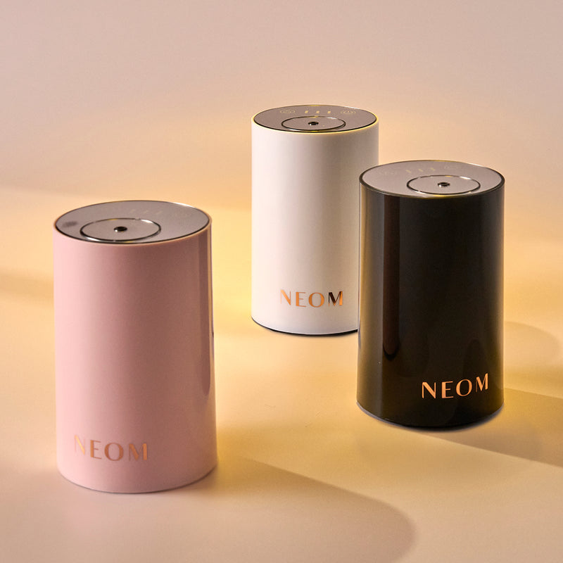 Three NEOM pod minis on a gradient background