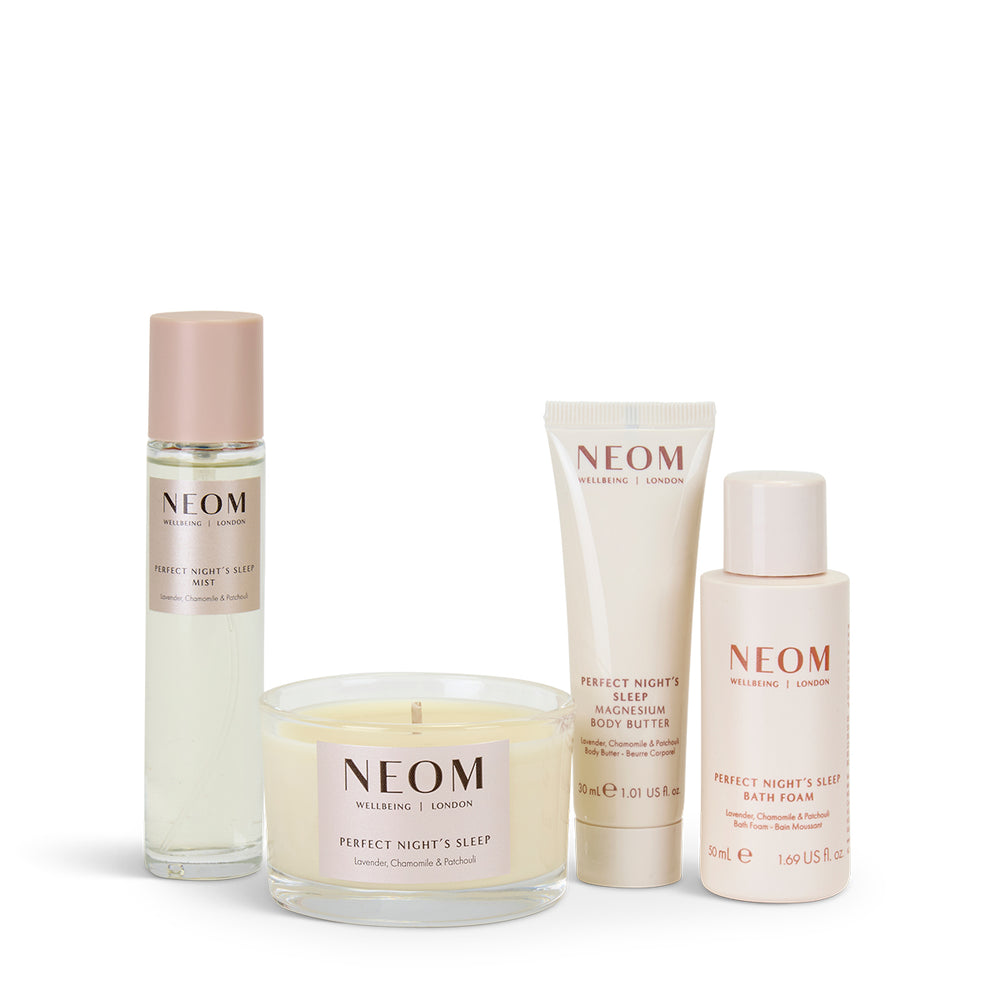 NEOM Sleep products including a candle, bath foam, body butter and pillow mist on a white background