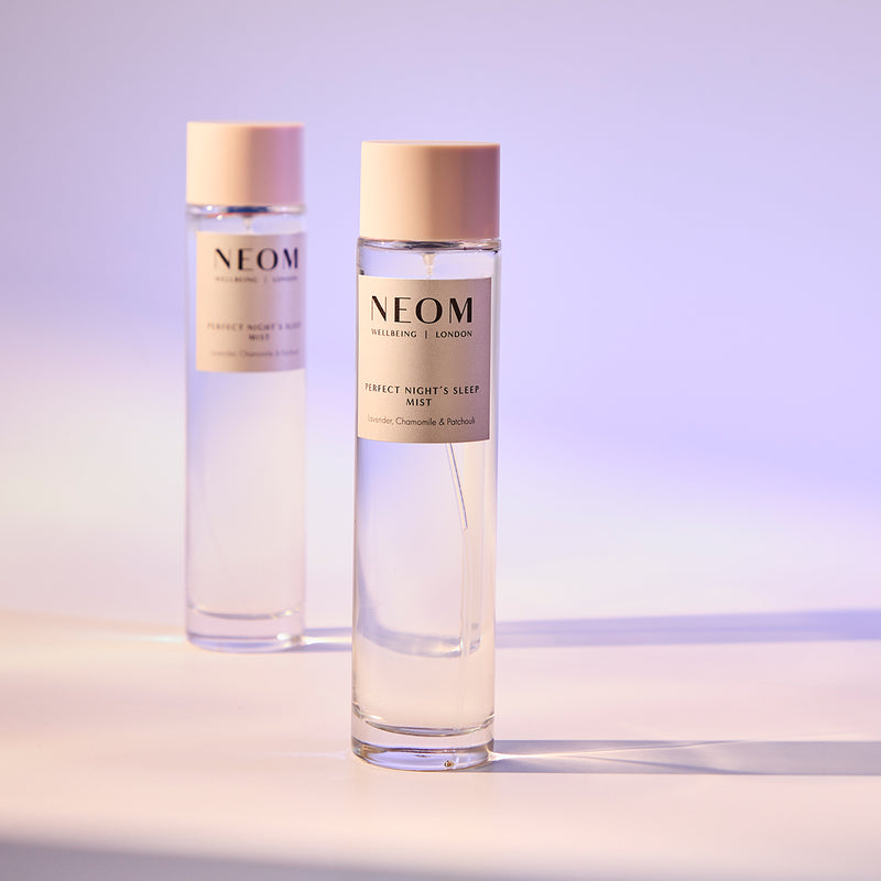 Two NEOM products on a gradient purple background