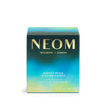 NEOM candle packaging with gradient blue and green design on a white background