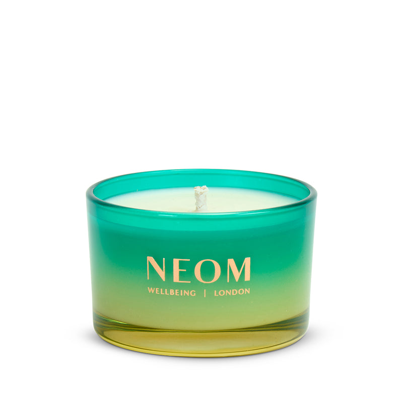 Neom candle with gradient green and yellow design on a white background