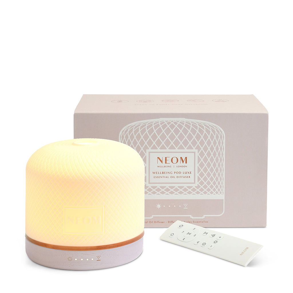 NEOM electric pod luxe diffuser with packaging on a white background