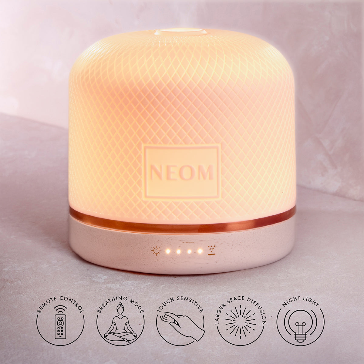 NEOM Pod Luxe with roundels saying :
'REMOTE CONTROL'
'BREATHING MODE'
'TOUCH SENSITIVE'
'LARGER SPACE DIFFUSION'
'NIGHT LIGHT'