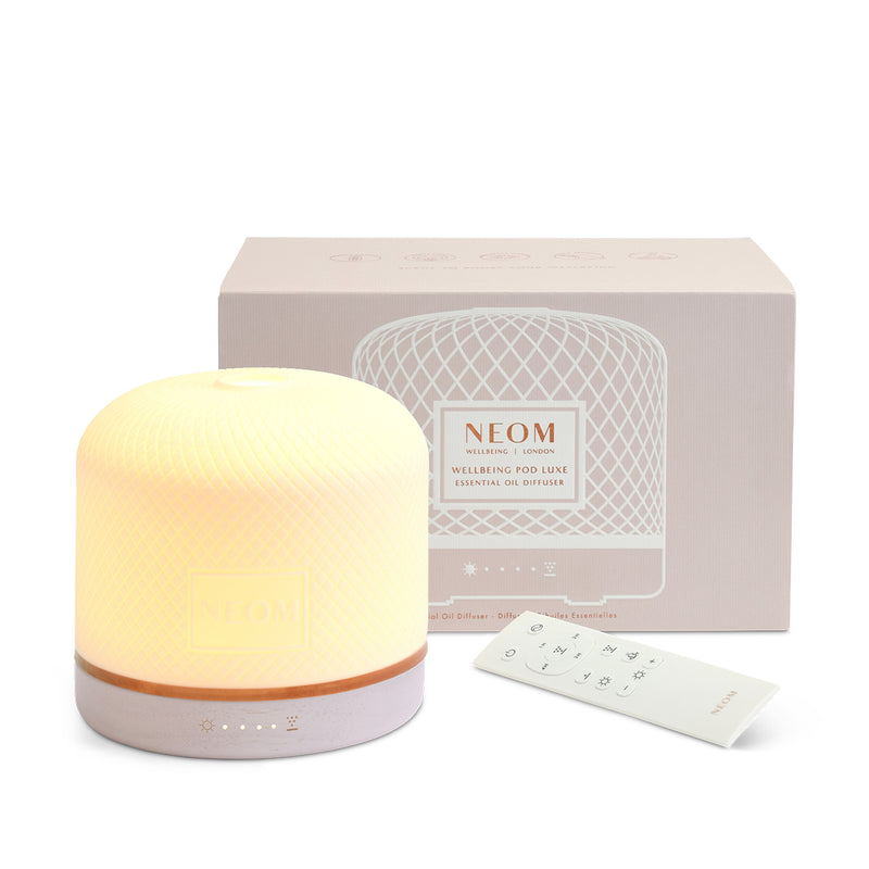 Neom essential oil diffuser with packaging on a white background