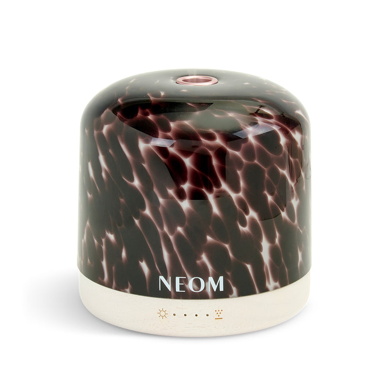 Marbled NEOM diffuser with 'NEOM' branding on a white background