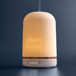 NEOM electric pod diffuser on a dark background