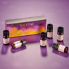 NEOM essential oil bottles on a purple background