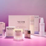 NEOM perfect night's sleep box including skincare and home fragrance products on a pink background 