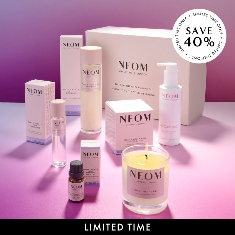 NEOM bath and body and wellness products on a pink background. Save 40%.