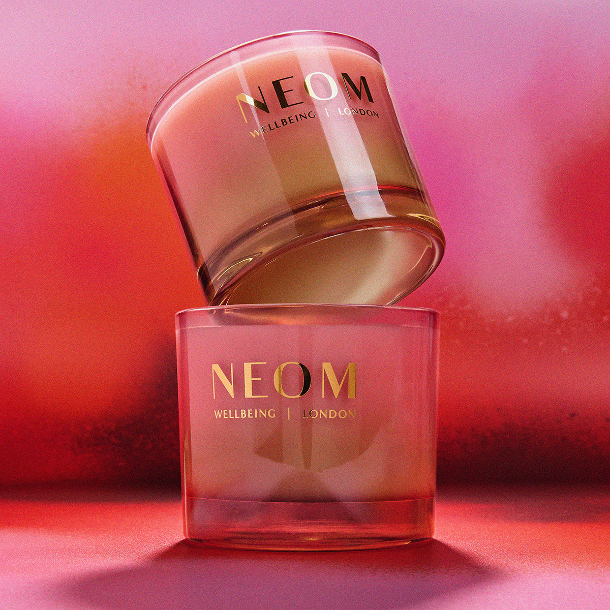 Two NEOM skincare products on a pink background