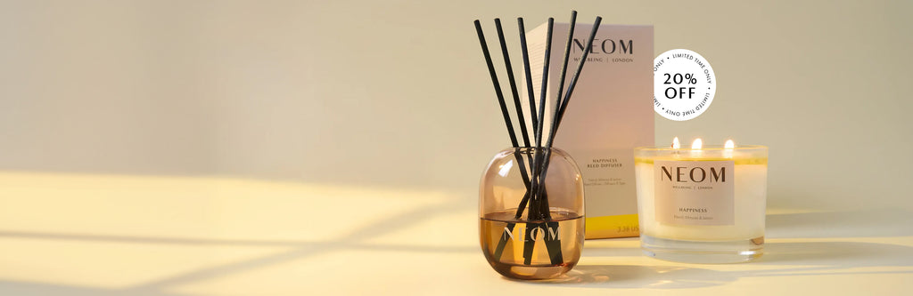 NEOM happiness reed diffuser and 3 wick candle with a '20% off limited time only' roundel on a neutral background 