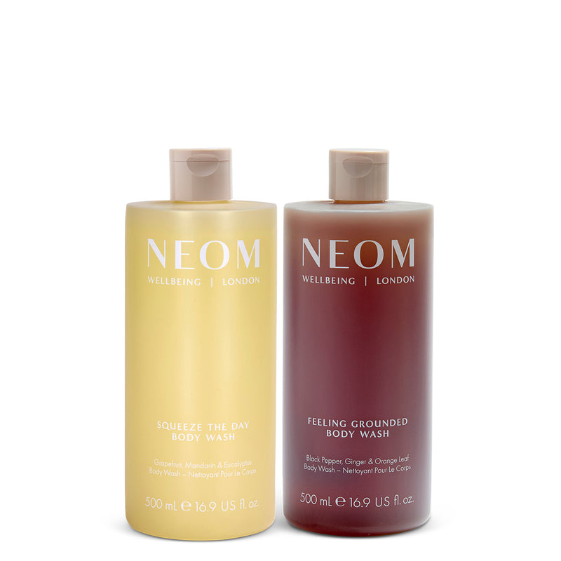 NEOM squeeze the day body wash and feeling grounded body wash on a white background