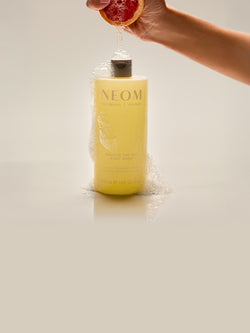 NEOM Squeeze the Day citrus body wash with fresh grapefruit juice and foaming lather