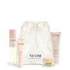 NEOM Sweet Dreams Travel Kit including a pillow mist, sleep pen, wonder balm and body butter with a white drawstring bag on a white background.