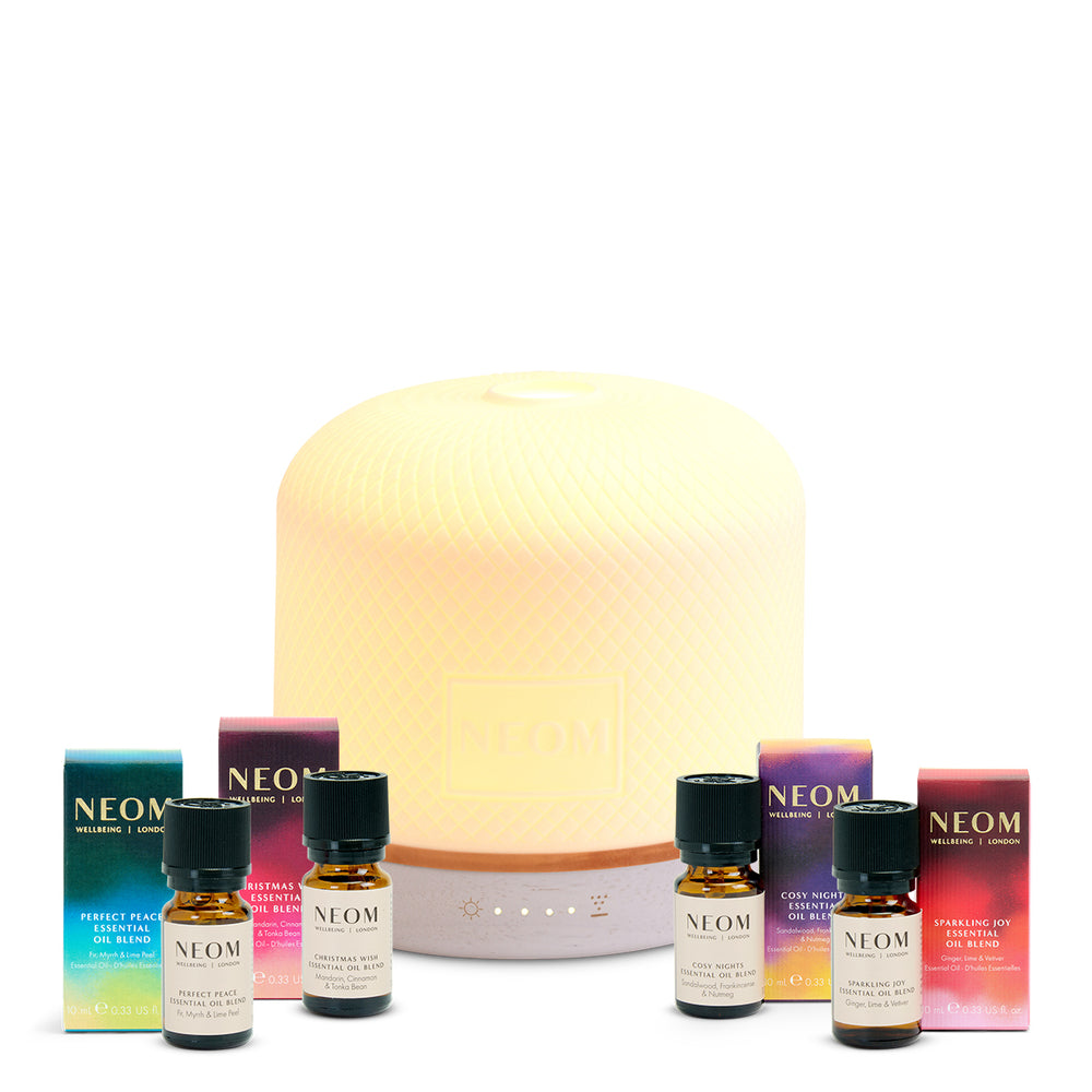 NEOM diffuser and essential oils on a white background
