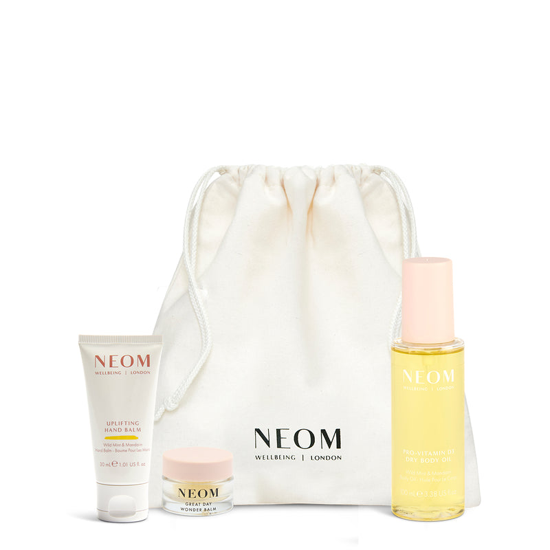 NEOM skincare products with a drawstring bag