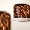 NEOM pod luxe electric diffuser with a tortoiseshell pattern on a light background