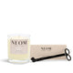 NEOM happiness candle and wick trimmer on a white background