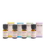 Collection of NEOM essential oil bottles and boxes on a white background