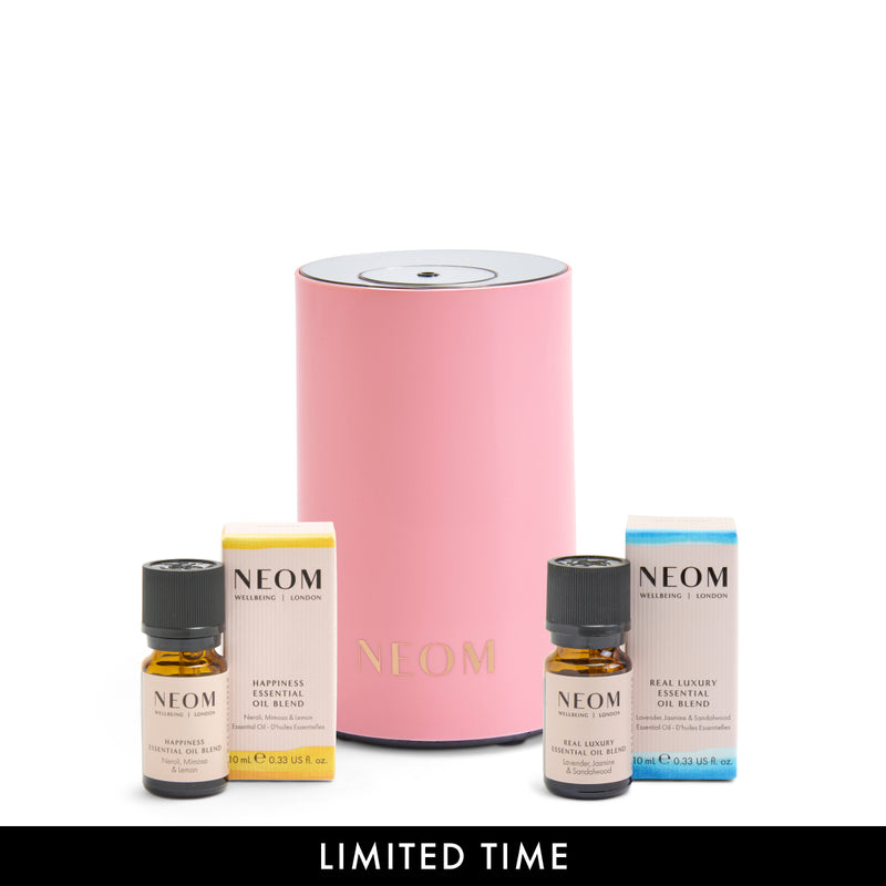 NEOM pod mini in pink and essential oil blends on a white background.