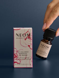 NEOM essential oil bottle and box on a dark background